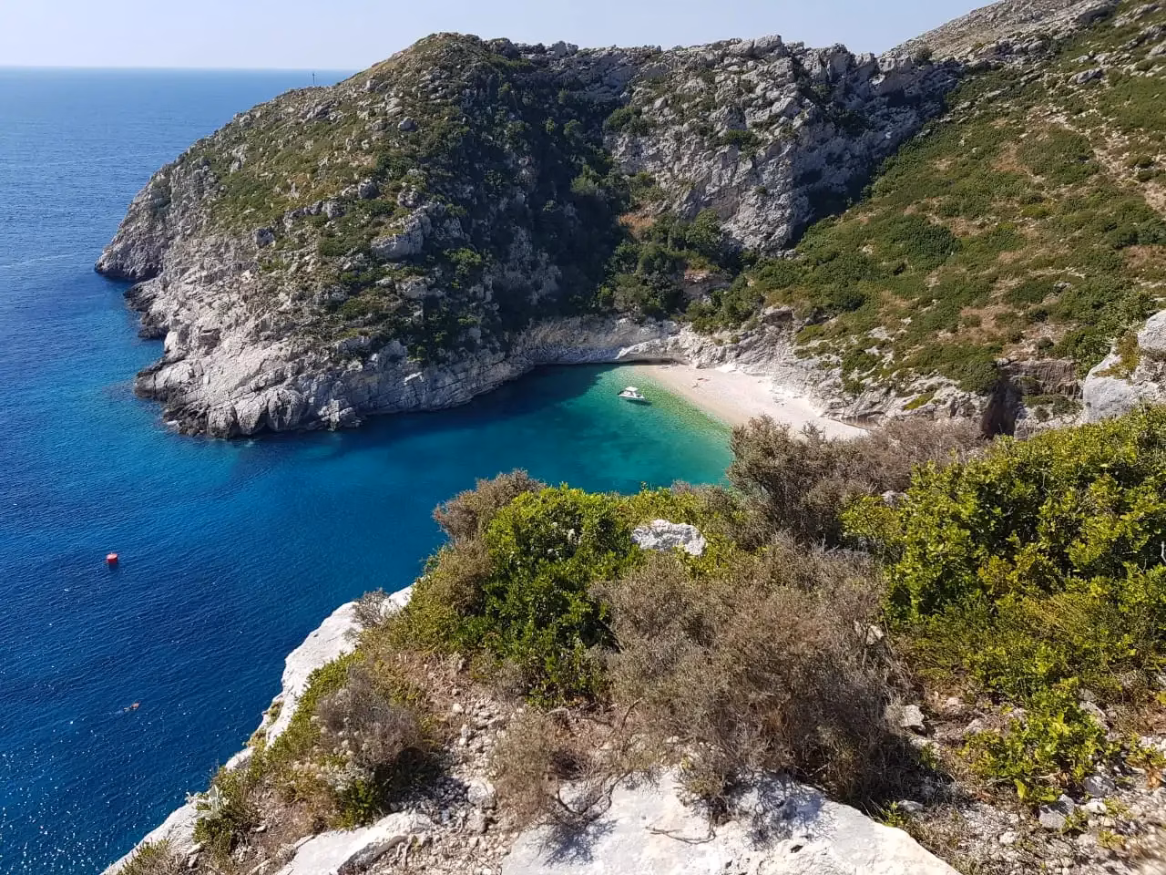 Grama Bay in Karaburun near Vlora — white-pebble beach, turquoise water and cliffs